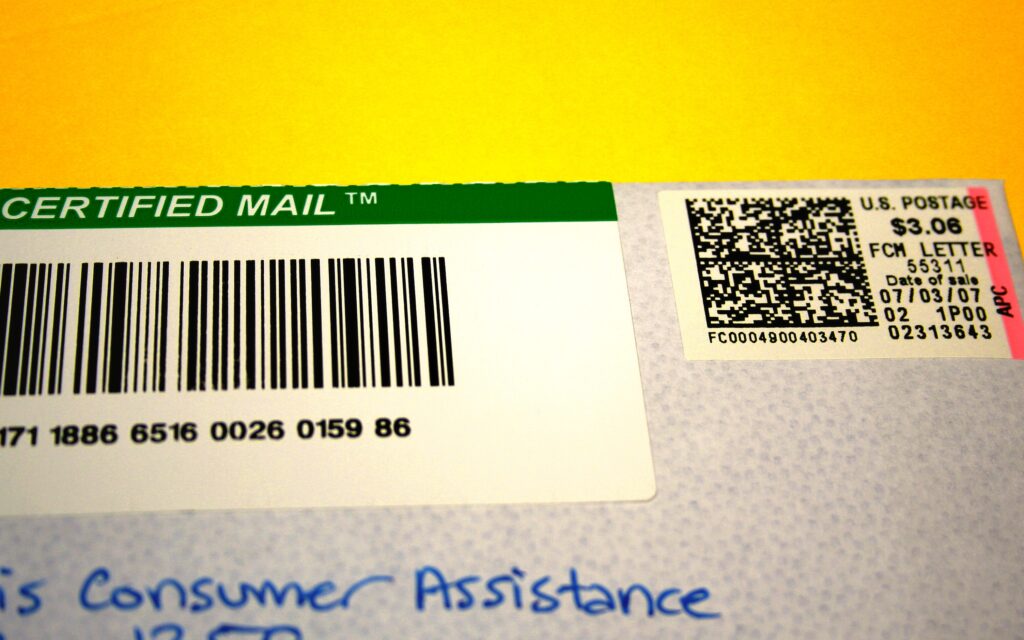 Enveloppe de courrier recommand&eacute; pos&eacute;e sur un bureau &agrave; c&ocirc;t&eacute; d'un stylo